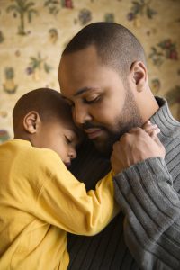 Father Smiling Holding Young Son