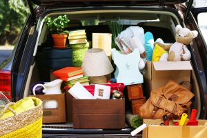 Moving boxes and suitcases in trunk of car, outdoors